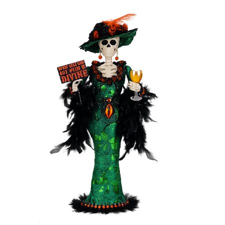 Decorative figure of a skeleton in a green dress with black feathers, holding a glass and a sign, on a white background.
