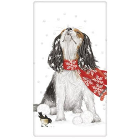 White kitchen towel with a Spaniel dog wearing a red scarf out in the snow looking up at snowflakes. Small black and white bird and snowballs by his paws.