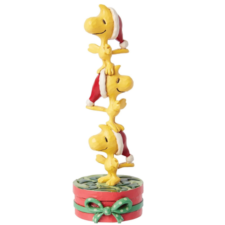 Resin figurine of three Woodstocks in Santa hats, stacked on top of a round gift.