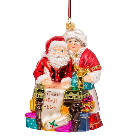 Ornament of Santa and Mrs. Claus at work table with list of toys.
