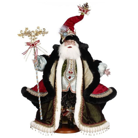 Santa wearing a red stocking cap, a long red cloak trimmed in black fur and a green robe underneath.