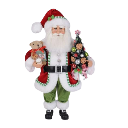 Santa figurine wearing red jacket and hat trimmed with white fur and green striped border. He's holding a tree with cookie decorations, a teddy bear and milk. The tree lights up.
