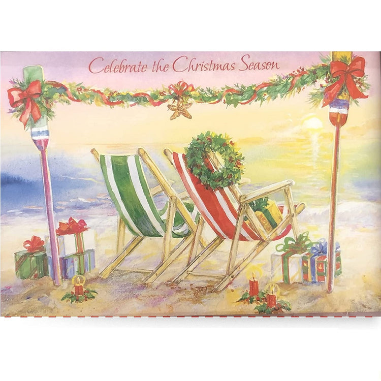 Christmas card shows 2 stiped beach chairs in the sand. 1 chair is striped green and white and the other is red and white striped with a greenery wreath hung on one corner.  There are 2 tiki torches with a strand of greenery garland hung between them with a hanging starfish in the middle.  2 lit candles and  5 gifts in the sand. 