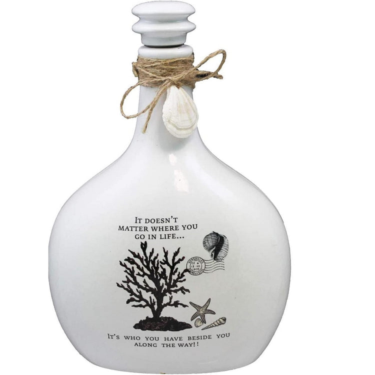 White jug with black coral, accented with shells, starfish and a postage tamp.  Twine accent on neck of bottle and shell dangling from twine.  White top.