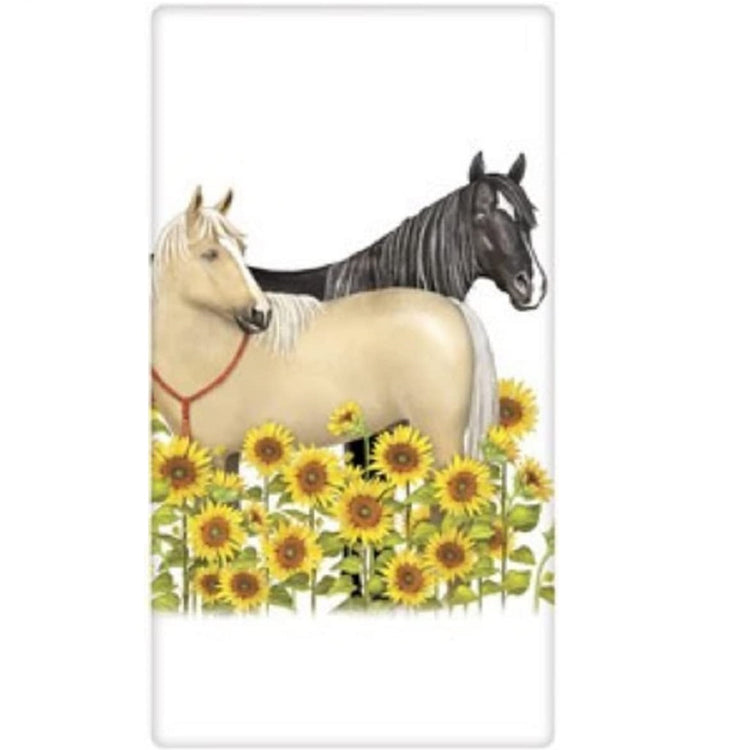 White towel with a black horse and a tan horse standing in a field of sunflowers