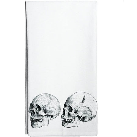 White kitchen towel with 2 black and white skulls printed on towel.
