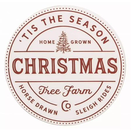 White metal sign that says "Tis The Season Home Grown Christmas Tree Farm" in red lettering.