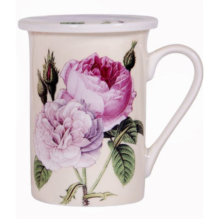 White tea cup with pink flowers with greens leaves on the side.