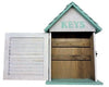 House shaped box with teal roof and white wash walls "KEYS" box is open showing 2 rows of hooks.