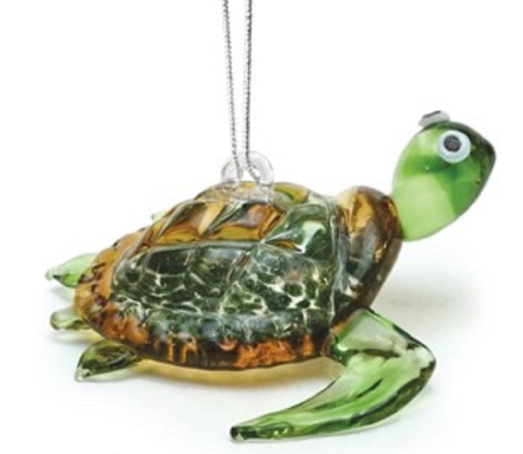 clear green glass sea turtle ornament with brown & gold shell. Turtle in swimming position. Silver hanger connects to back.