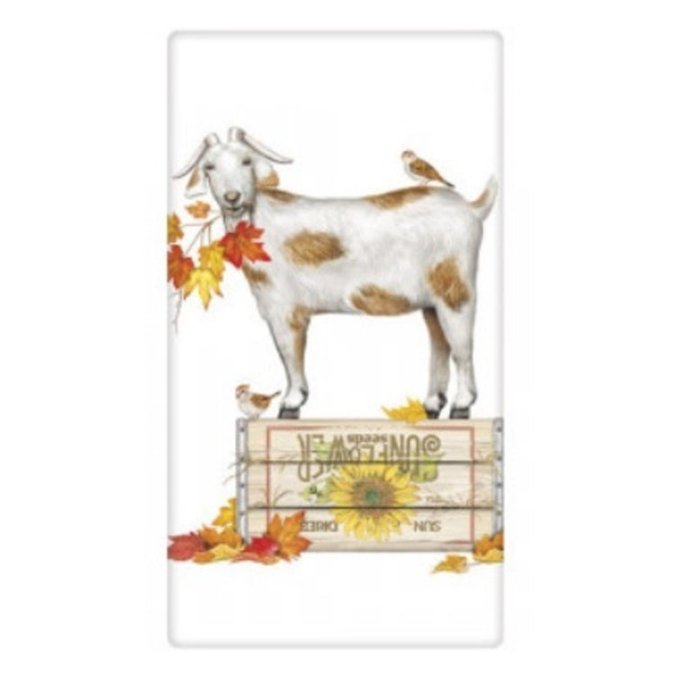 White & brown goat with birds & fall leaves.