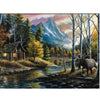 Wooden mountain scene with log cabin and canoe along a river, with a large deer across the river. This is the image for this puzzle.