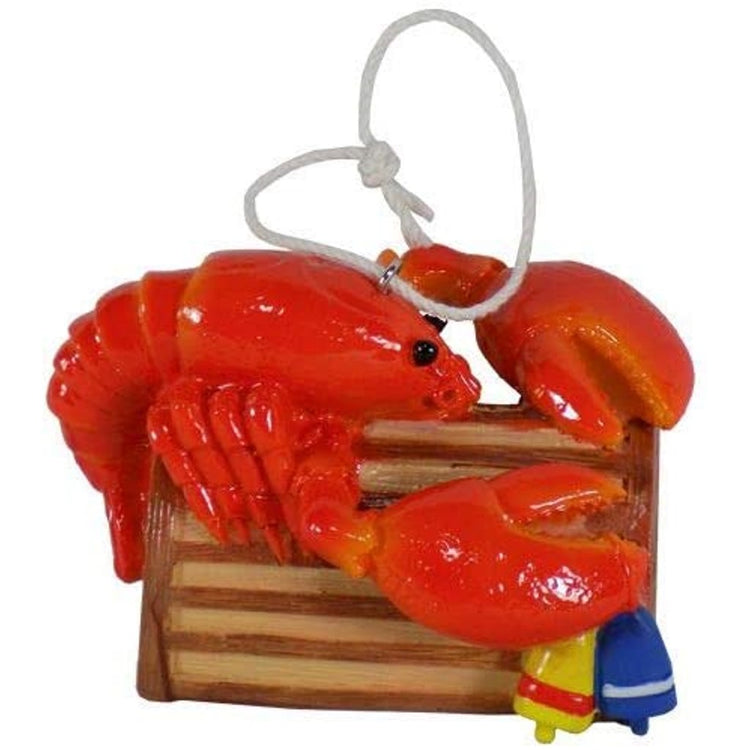 Hanging ornaments shaped like a red lobster on a brown lobster trap.