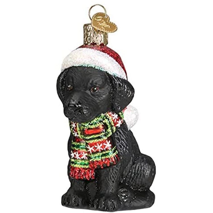 blown glass black labrador puppy ornament wearing scarf and santa hat.