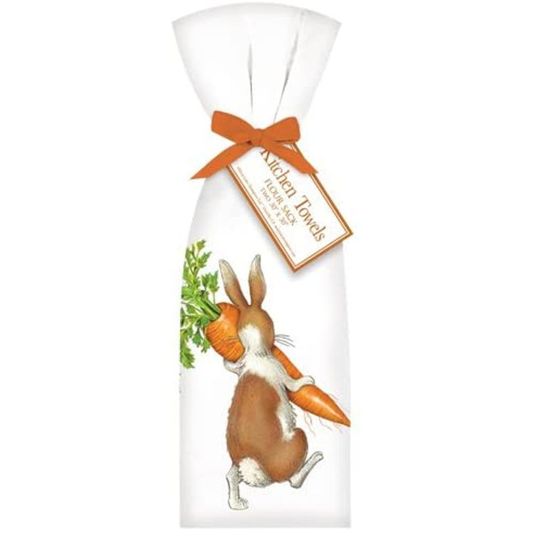 two white towels with brown and white rabbit carrying a large carrot, towels are tied together with orange ribbon.