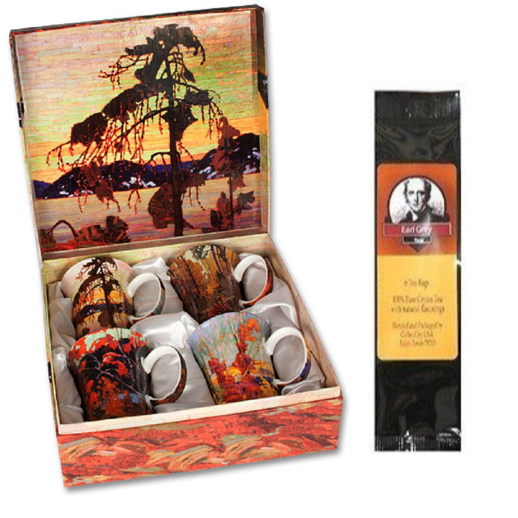 4 mugs, a gift box & a black package of tea bags. The box and the mugs all show artwork from Tom Thompson.