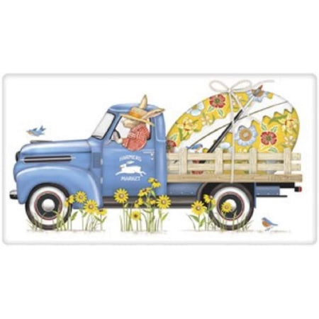 Folded white flour sack towel with bunny driving a blue pickup truck with large painted Easter egg in truck bed.