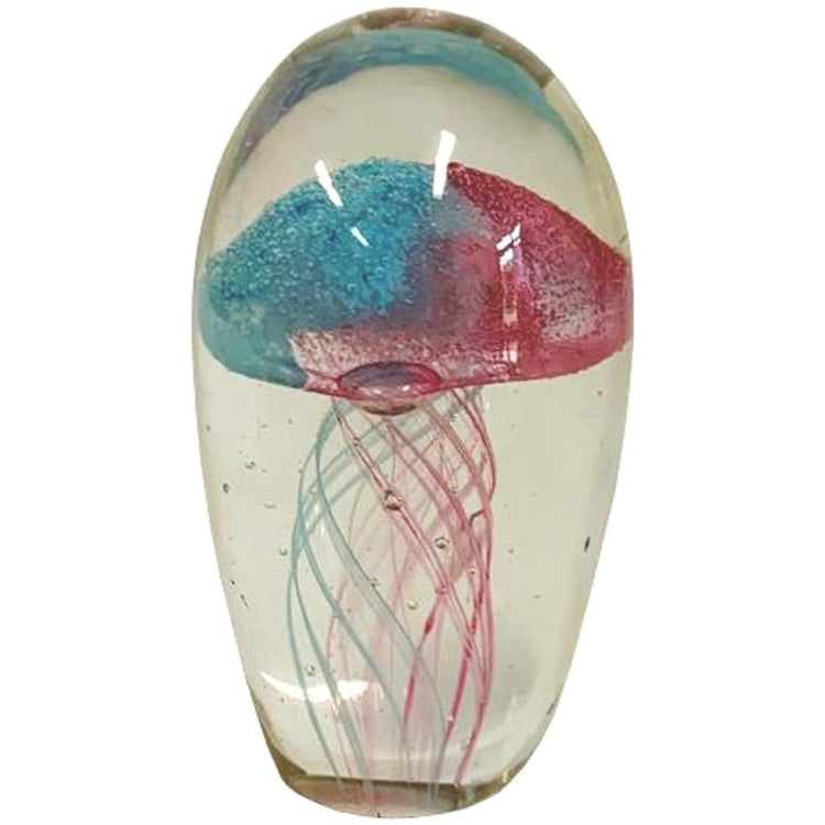 small glass paperweight with pink and blue swirled jellyfish design inside.