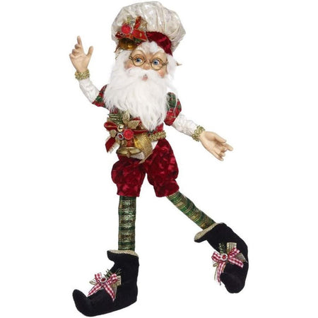White bearded elf with a red & green Christmas outfit & hat on.