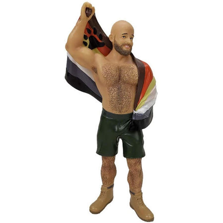 Burly man shaped figuring ornament.  Wearing black shorts, boots and carrying a pride flag.