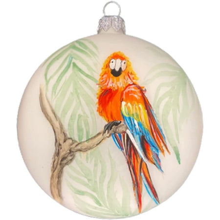 Ball ornament with a red parrot on a branch.