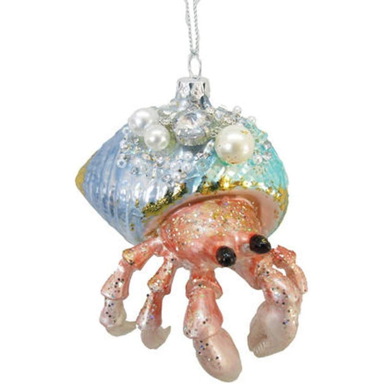 coral colored hermit crab with a blue jewel embellished shell