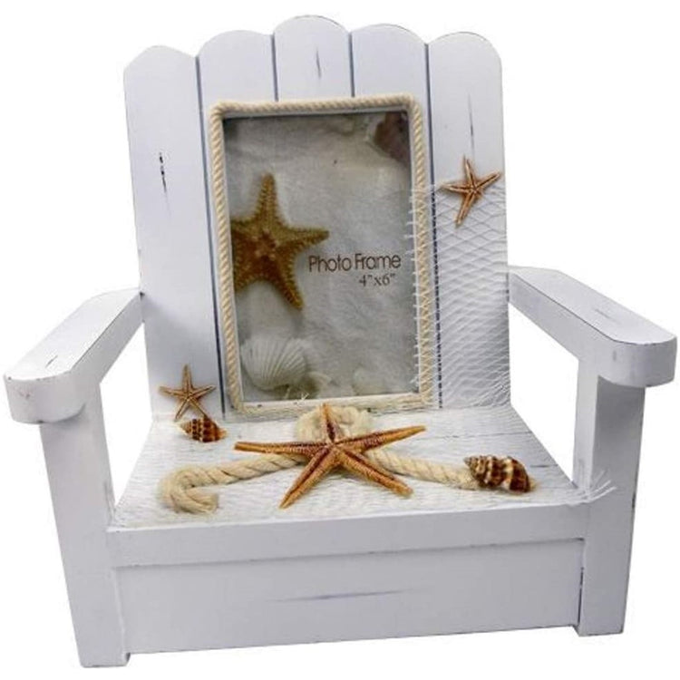 White Adirondack chair photo chair with starfish and shells and rope on it.