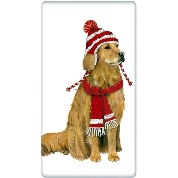 White towel. Golden retriever sits wearing red & white knit hat & scarf.