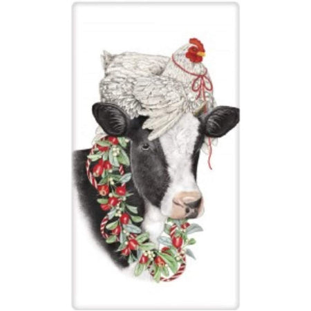 White chicken with red ribbon on a cows head with a wreath around the cows neck.