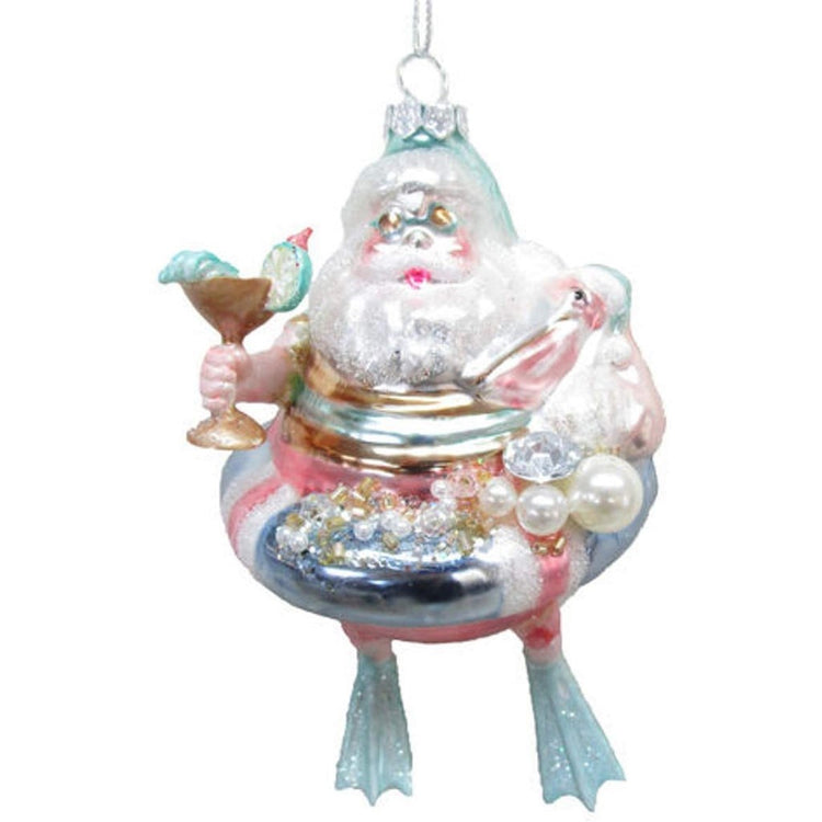 santa in a float with a drink, holding a pelican & wearing flippers 