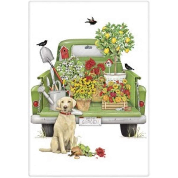 green truck with flowers, plants & birdhouses & a lab