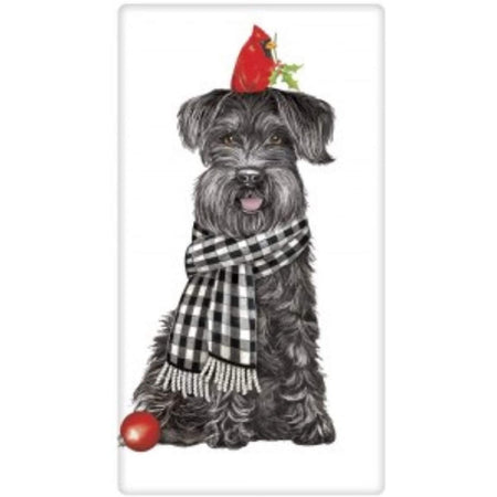 black schnauzer dog in black checked scarf with a cardinal on his head.