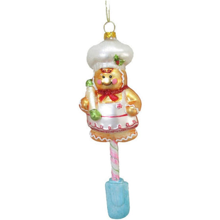 Blown glass ornament shaped like a gingerbread man with a mixing spoon hanging down.