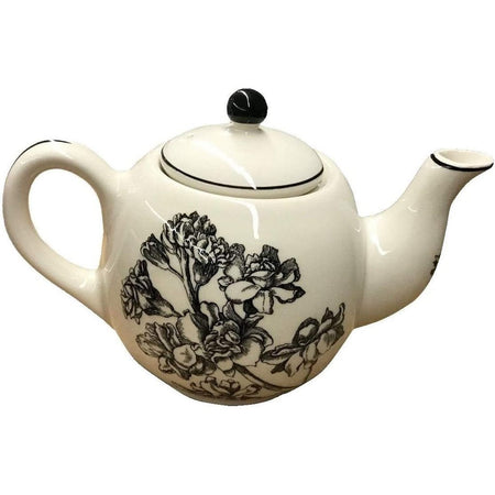 Cream colored teapot with black floral print on it.