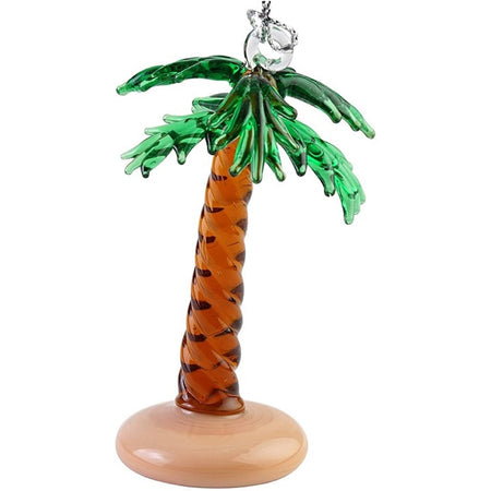 Glass palm tree ornament with green branches, brown trunk & tan base. Hanger connects to top of tree with string.