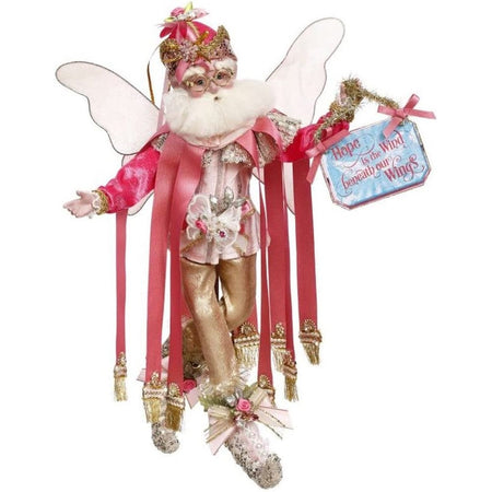 White bearded fairy with a pink outfit on & a sign.