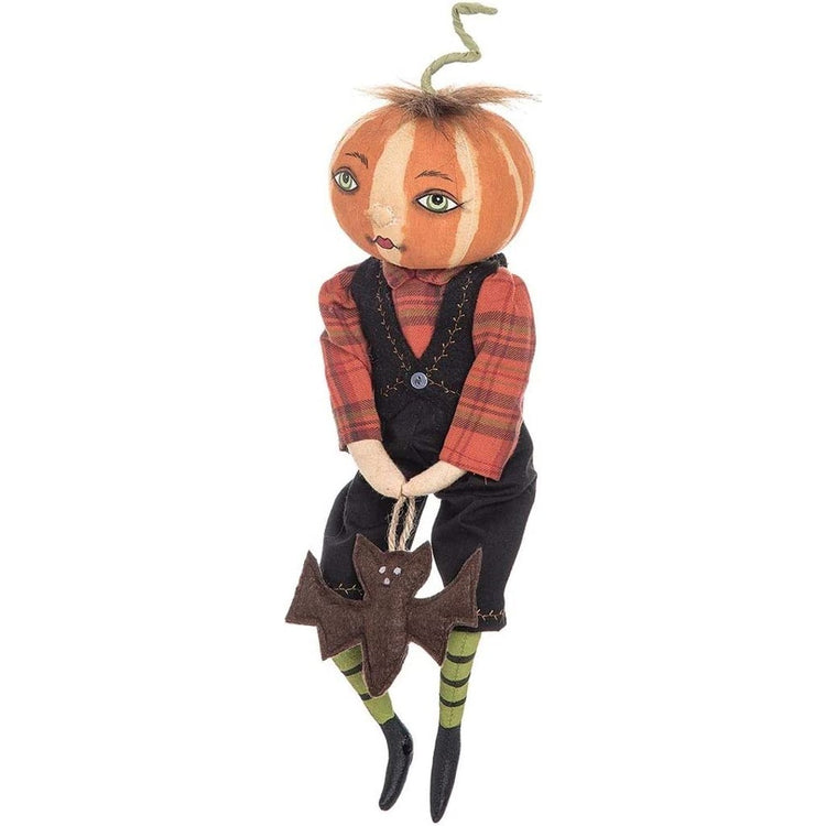 Pumpkin head figurine with overalls & a plaid shirt.
