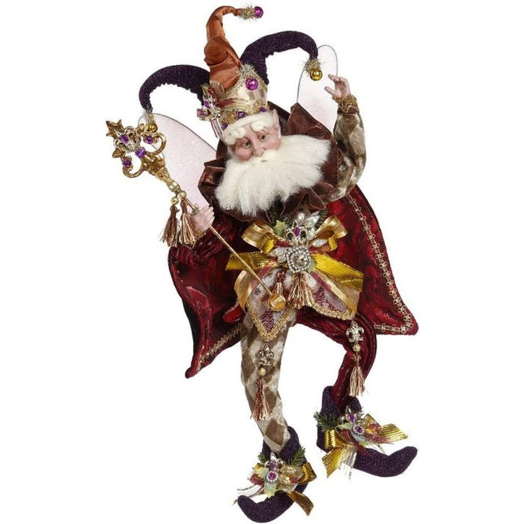 White bearded fairy with a maroon velvet outfit with gems on.
