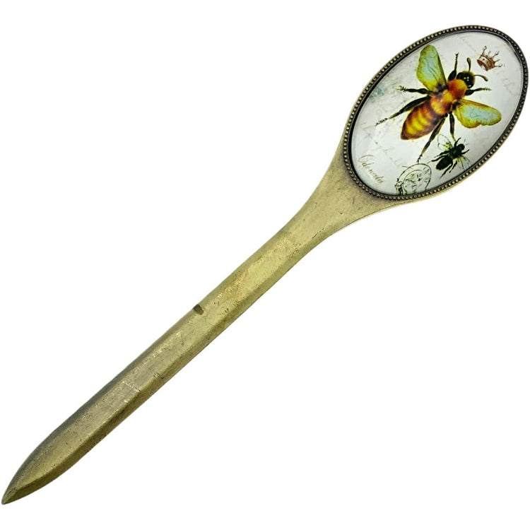 Bronze letter opener with an oval shaped handle. The handle has a glass face, showing a bee with a crown.