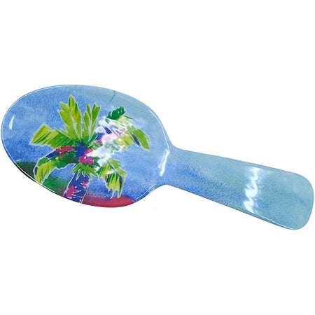 Blue spoon rest with green palm tree on it.