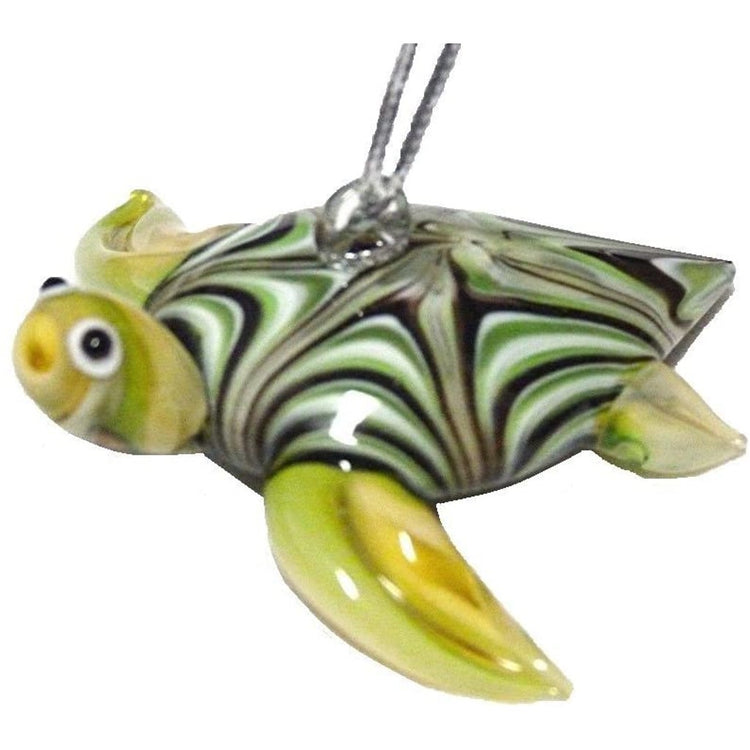 blown glass turtle ornament. The head and legs are green , the shell has a swirl of green brown and white.