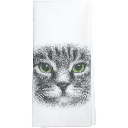 White towel with a grey & black striped cat face with green eyes.