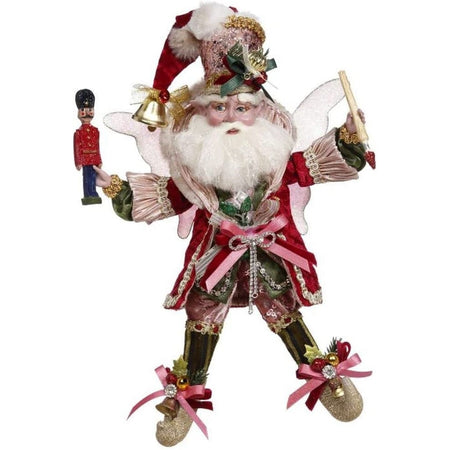 bearded fairy in blush pink and red outfit holding a paintbrush and a toy soldier