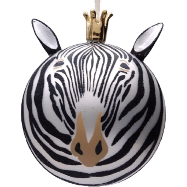 White & black zebra with a crown ball ornament.