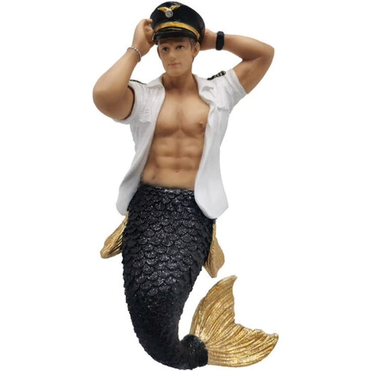 Ornament of a Merman wearing white pilots shirt, unbottoned, with a pilots cap, and his tail is black with gold fins.