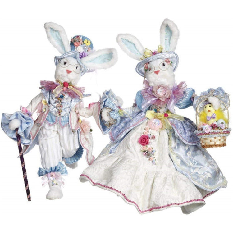 2 Bunny rabbit figures with elaborate pastel blue clothing including coats, vests and hats.  Basket and cane adornments.