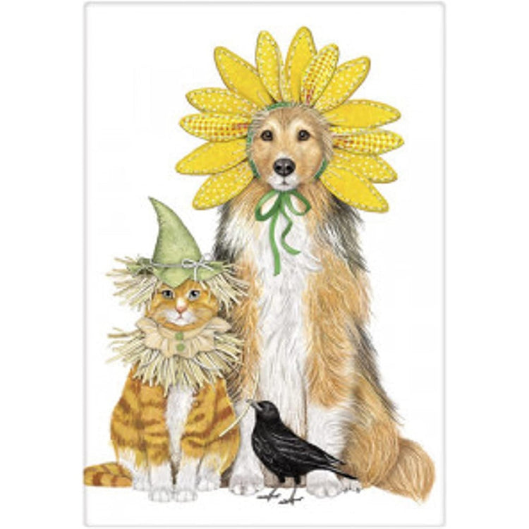 A dog & cat dressed as a scarecrow & a flower.