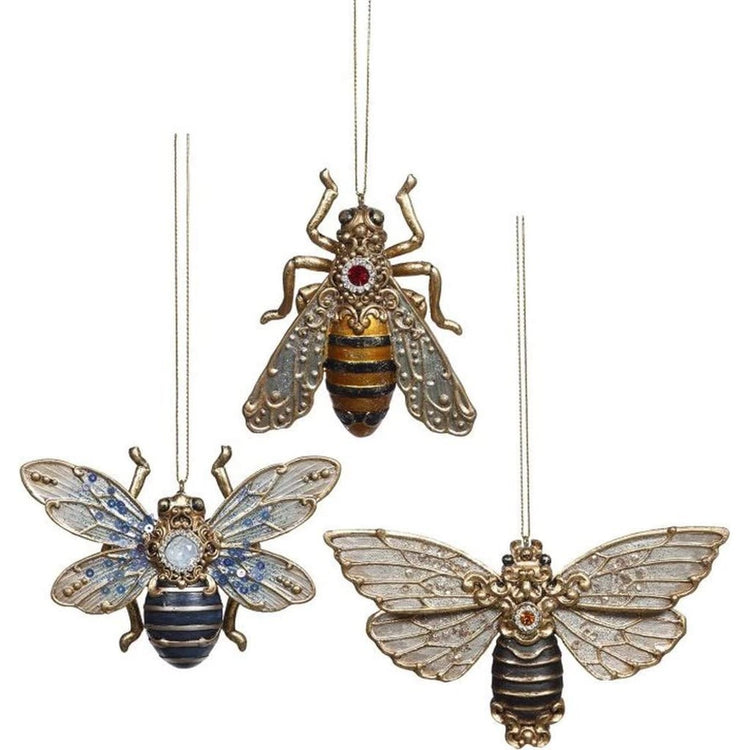 3 resin bee ornaments, on blue, on yellow, and one black, all have jewel accents.