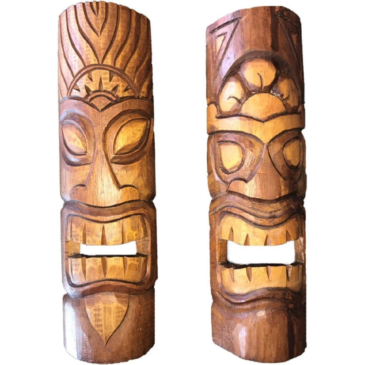 2 carved natural and stained wood tiki masks with open mouths.