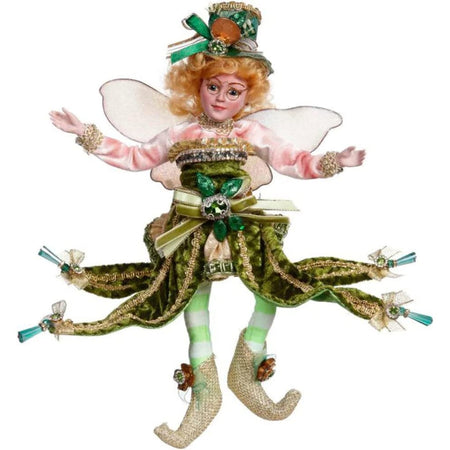 Ginger haired fairy girl in a green festive outfit.